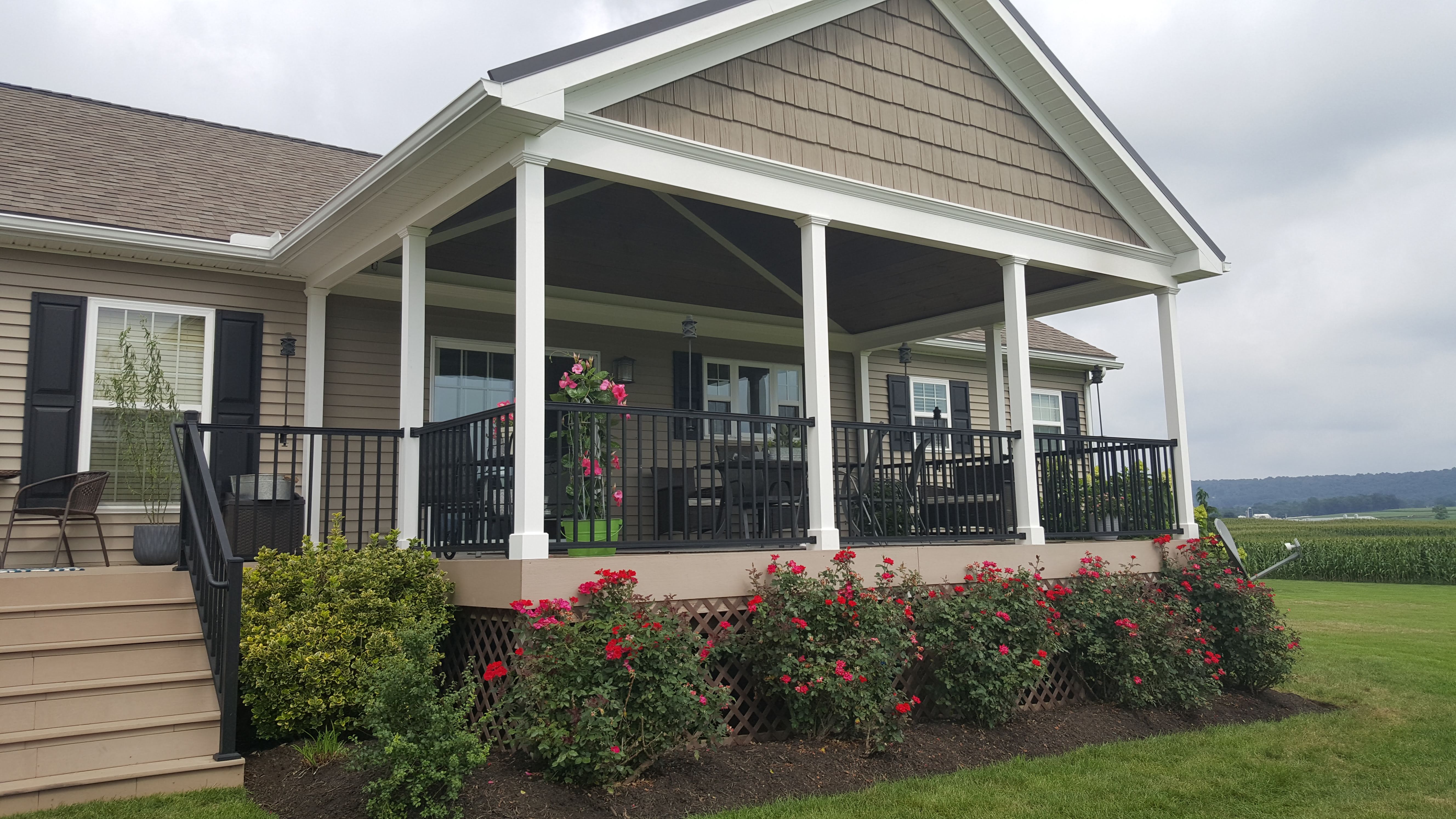Covered front porch with columns and landscaping