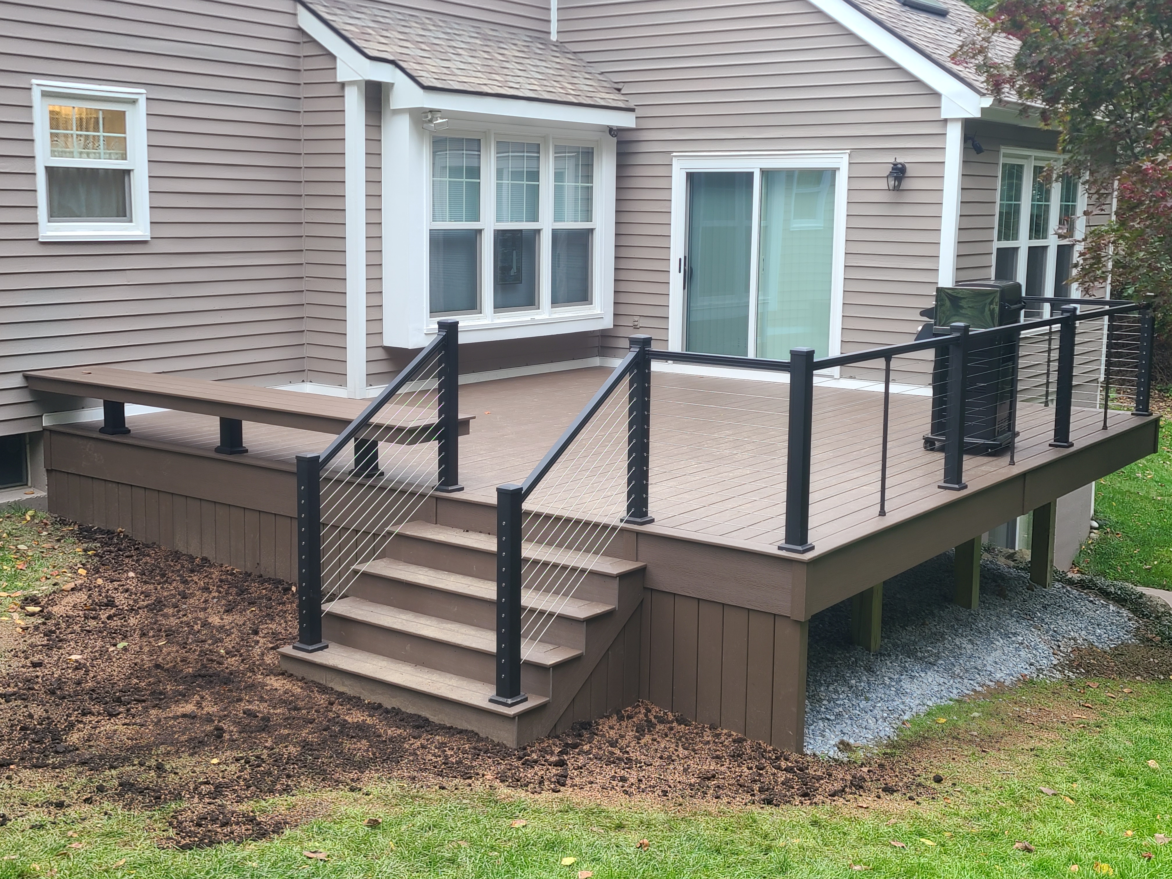 Deck with black railing and short stair run