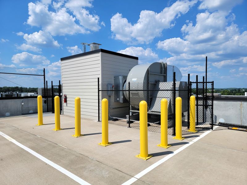 Yellow safety bollards protecting a commercial facility
